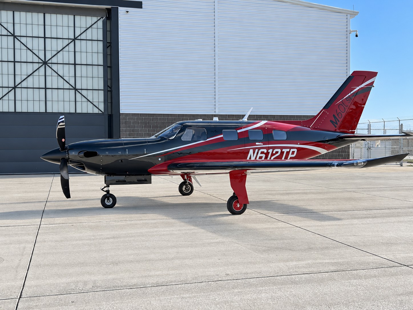 Red and black 2023 Piper M600 SLS N612TP on the ramp